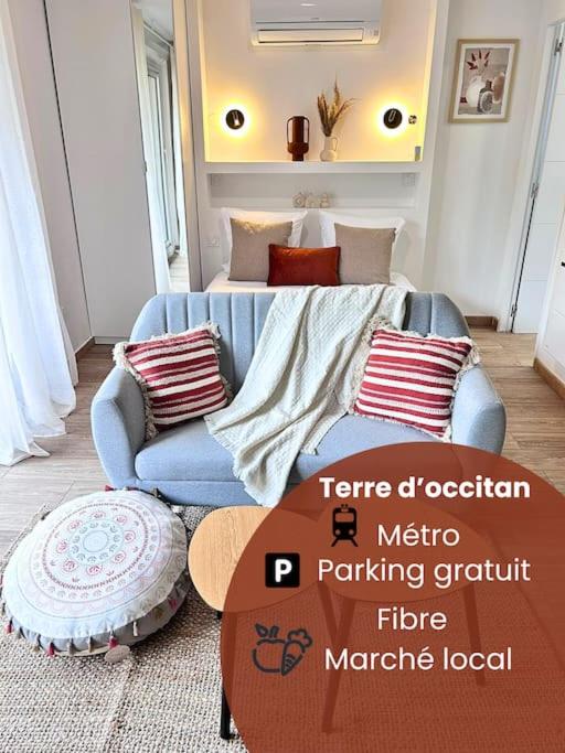 un salon avec un canapé bleu et une table dans l'établissement Terre d'occitan-Metro-Parking-Balcon, à Ramonville-Saint-Agne