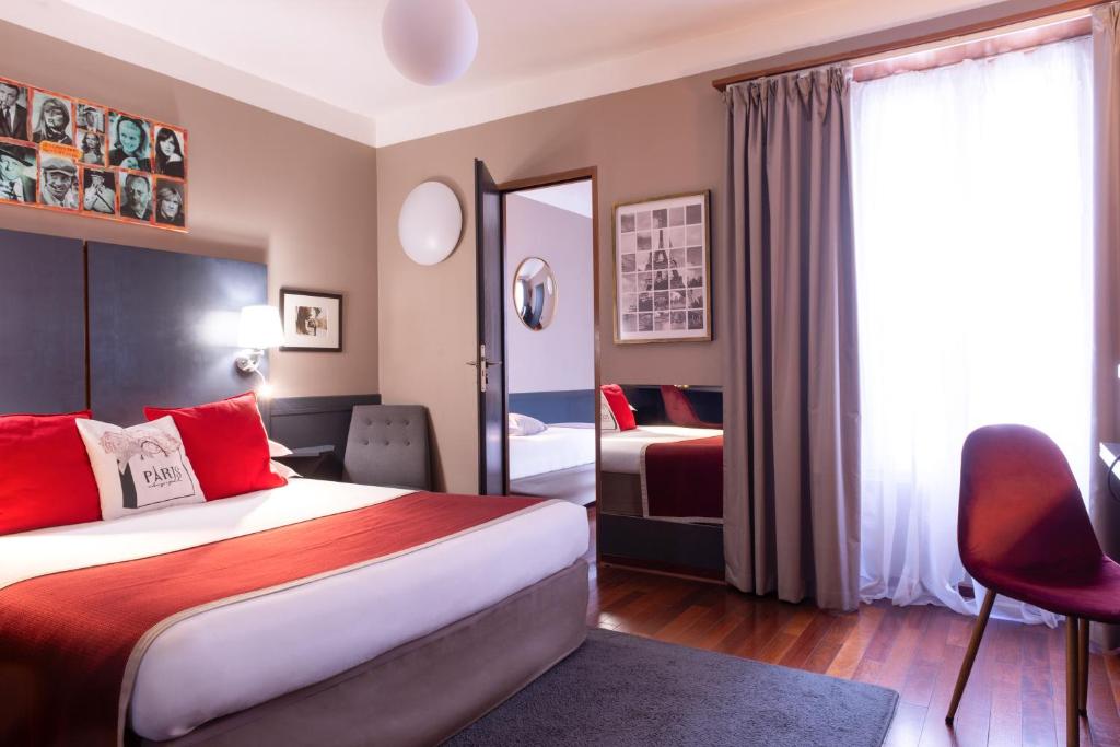 a hotel room with a bed and a mirror at George Sand in Paris