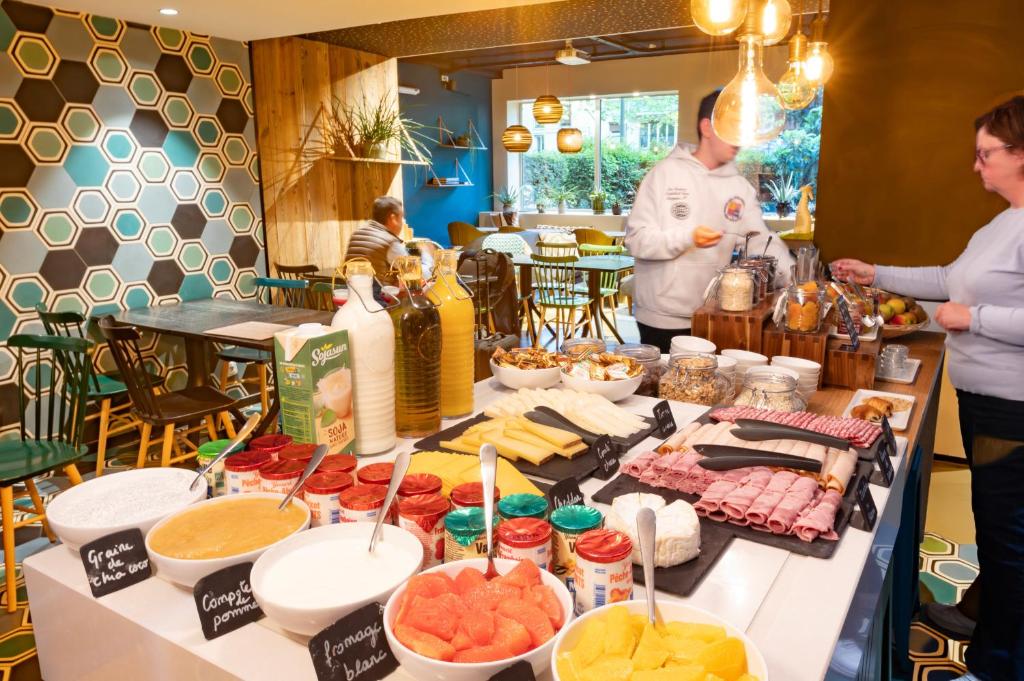 a buffet of food on a table in a restaurant at ibis Styles Paris 16 Boulogne in Paris