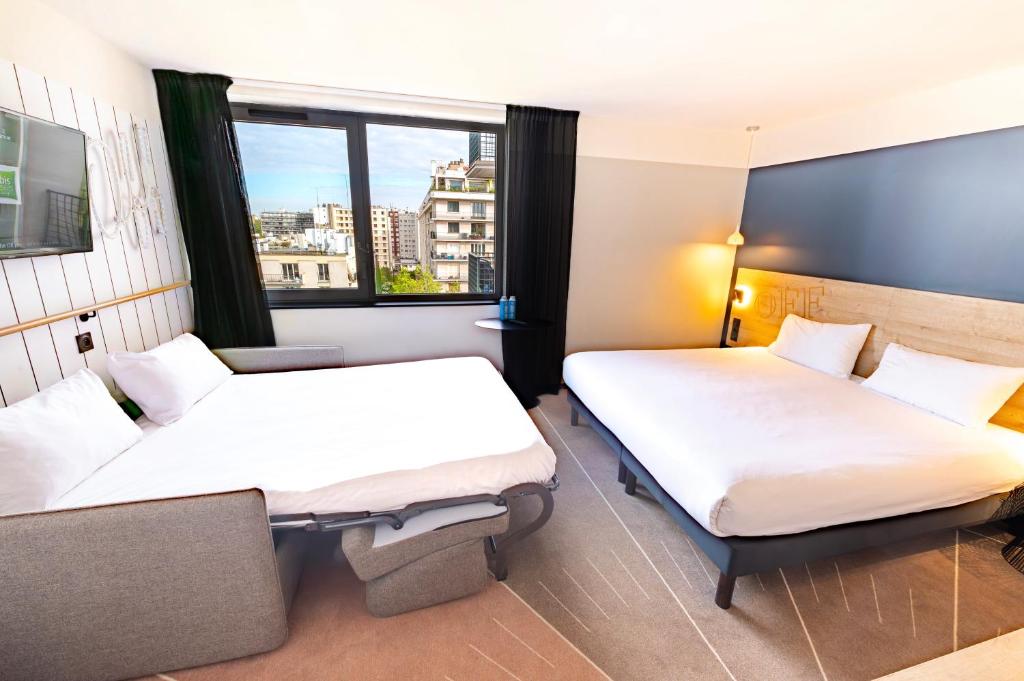 a hotel room with two beds and a window at ibis Styles Paris 16 Boulogne in Paris
