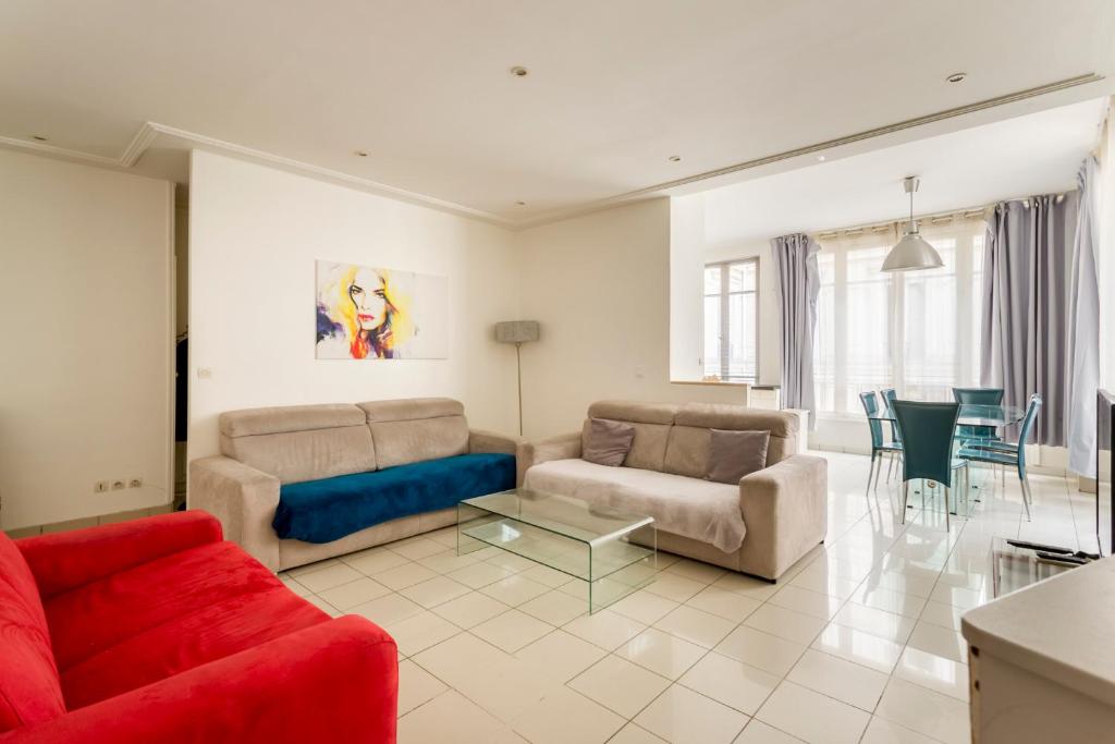 un salon avec deux canapés et une table dans l'établissement Champs-Élysées Lincoln - 2BDR, à Paris