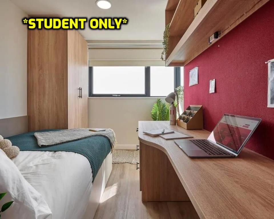 a bedroom with a desk with a laptop on it at Student Only Ensuite Rooms Zeni Bournemouth in Bournemouth