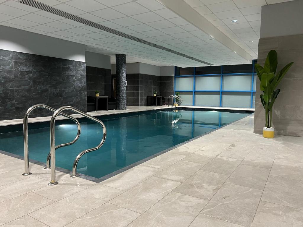 a large swimming pool in a hotel lobby at voco Reading in Reading