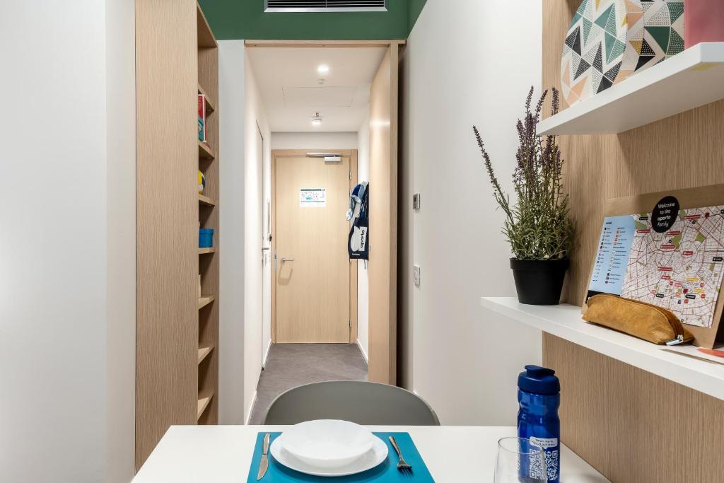 a room with a table and a hallway at aparto Milan Ripamonti in Milan
