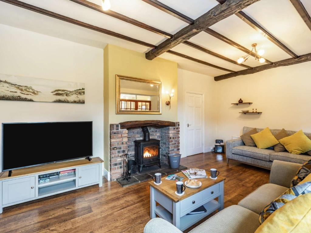 a living room with a television and a fireplace at 4 Bed in Keswick 86248 in Rosthwaite