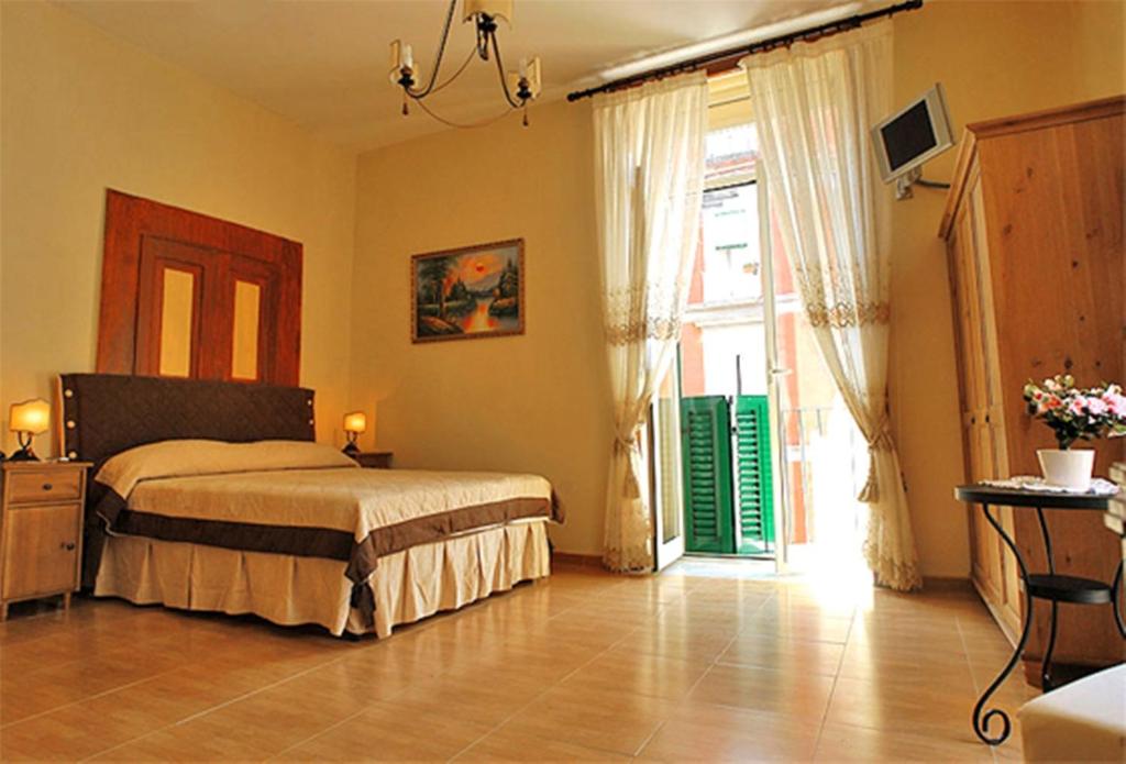 a bedroom with a bed and a large window at B&B Domus Gemi in Naples