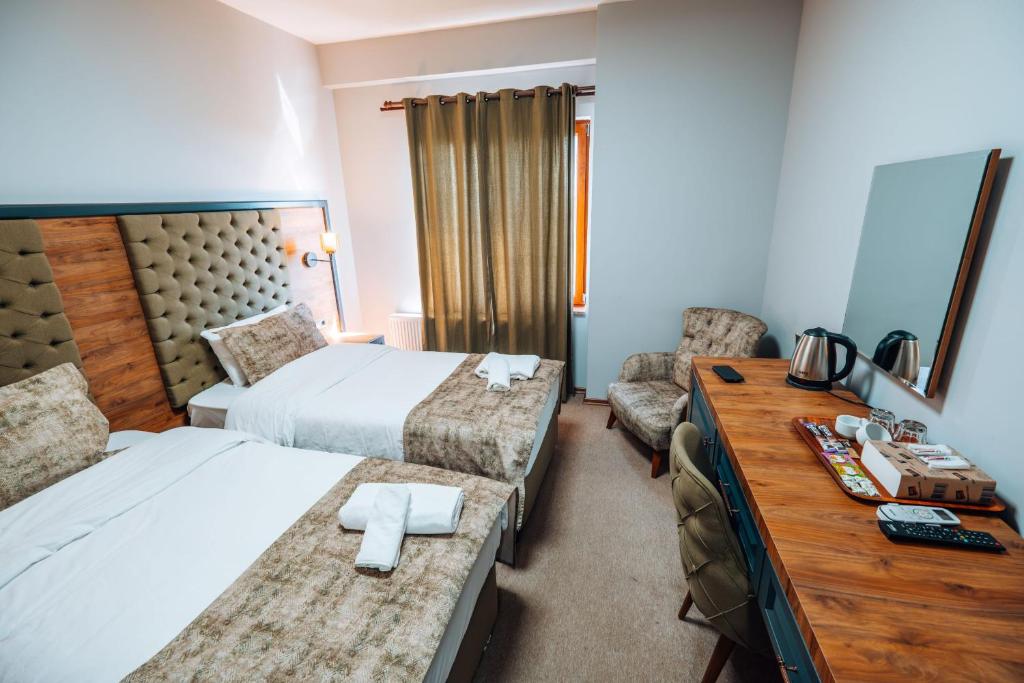 Postel nebo postele na pokoji v ubytování Mysia Olympos Hotel