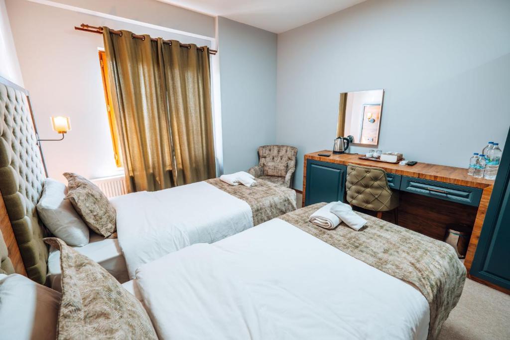 Postel nebo postele na pokoji v ubytování Mysia Olympos Hotel