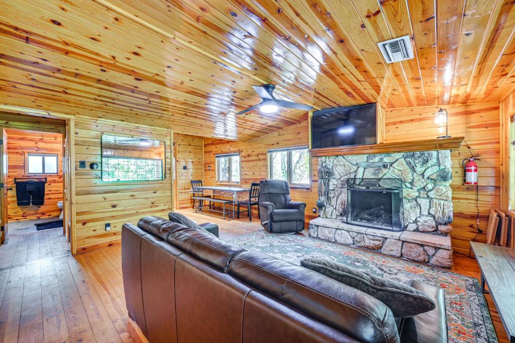a living room with a couch and a fireplace at Hike and Snow Play! Creekside Cabin in Payson in Payson