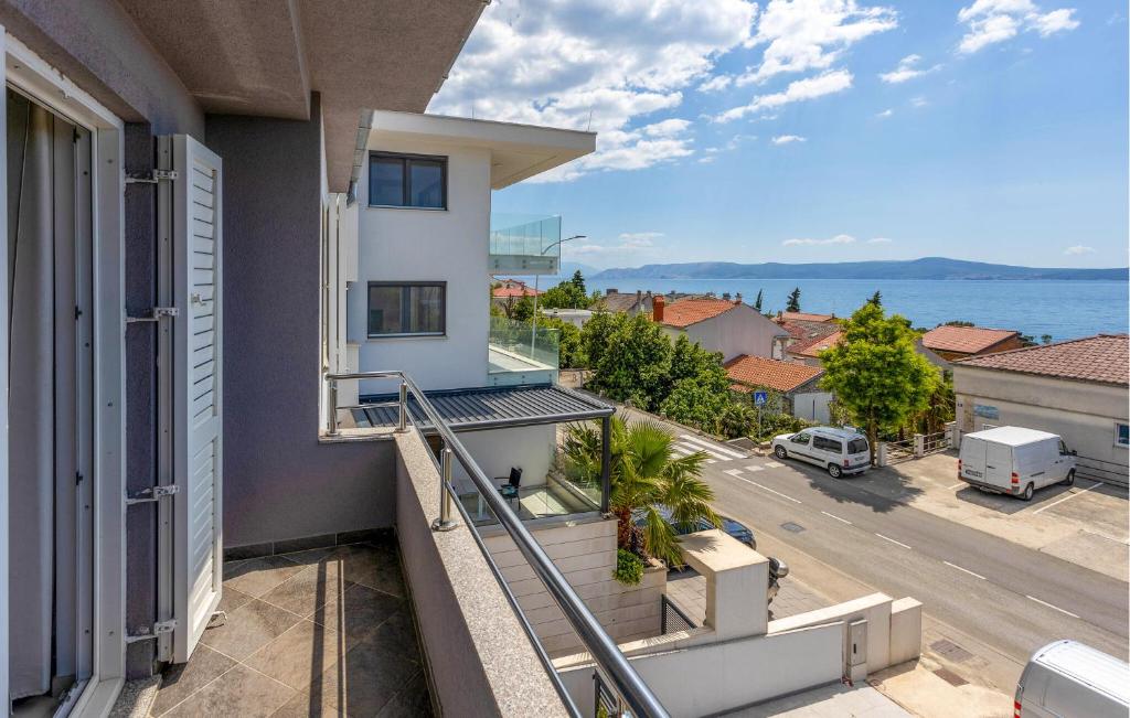 an apartment balcony with a view of the ocean at Stunning Apartment In Crikvenica With Kitchen in Crikvenica