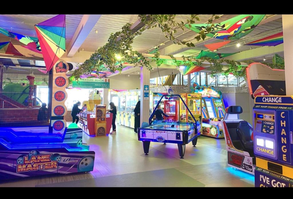a room with many arcade games in a store at WestSands Caravan in Selsey