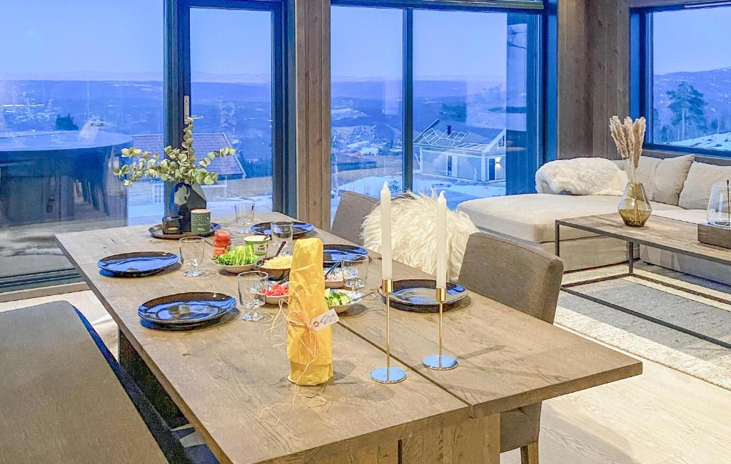 een houten tafel met borden eten in de woonkamer bij Lovely Home In Hnefoss With Kitchen in Hønefoss