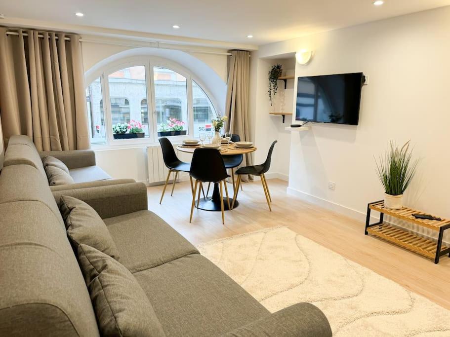 a living room with a couch and a table at Allée Royale in Annecy