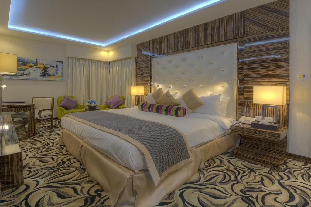 a large bedroom with a large bed in a room at Orchid Vue Hotel in Dubai