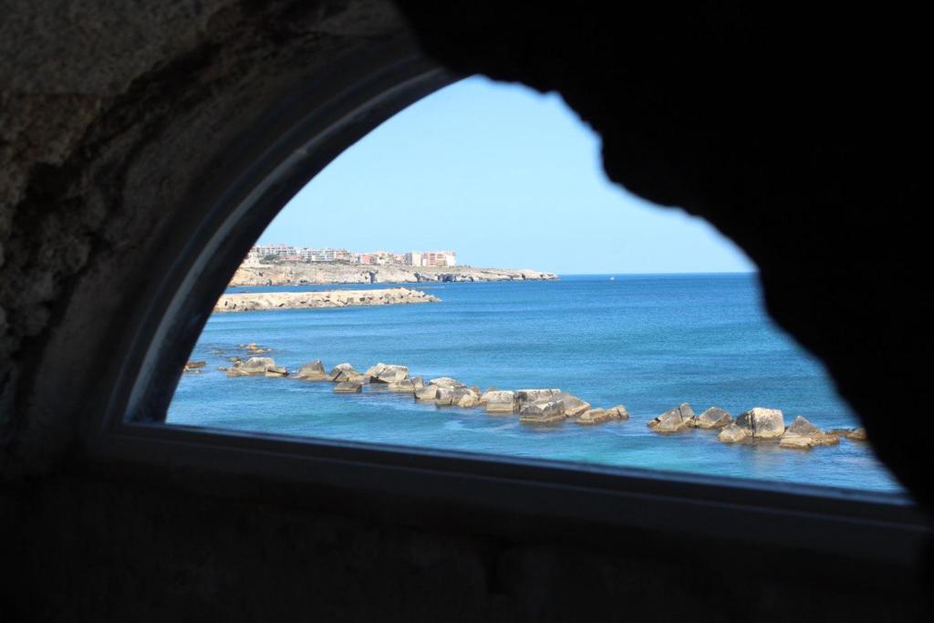 a view of the ocean from a window at Brezza Marina Ortigia in Siracusa