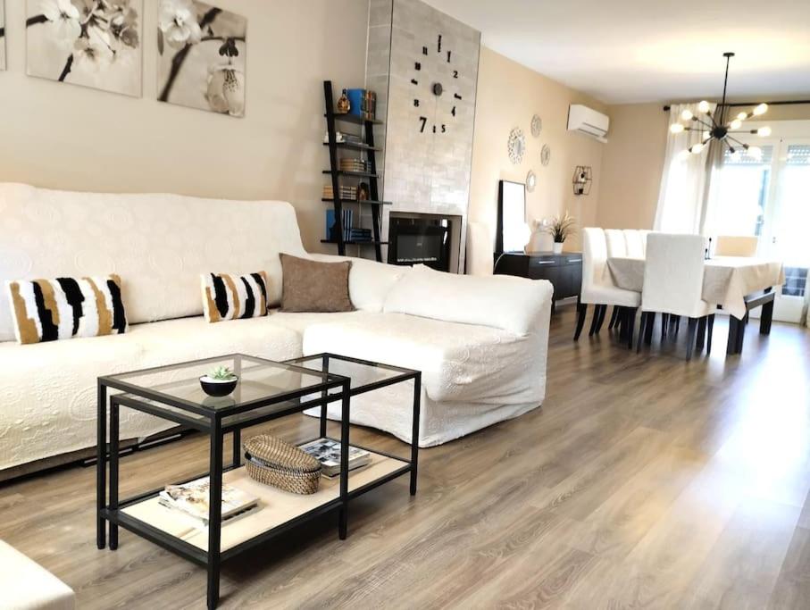a living room with a white couch and a table at Vivienda familiar cerca de Toledo y de Puy Du Fou in Burguillos de Toledo