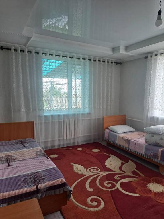 Postel nebo postele na pokoji v ubytování GuestHouse "ERKIN"