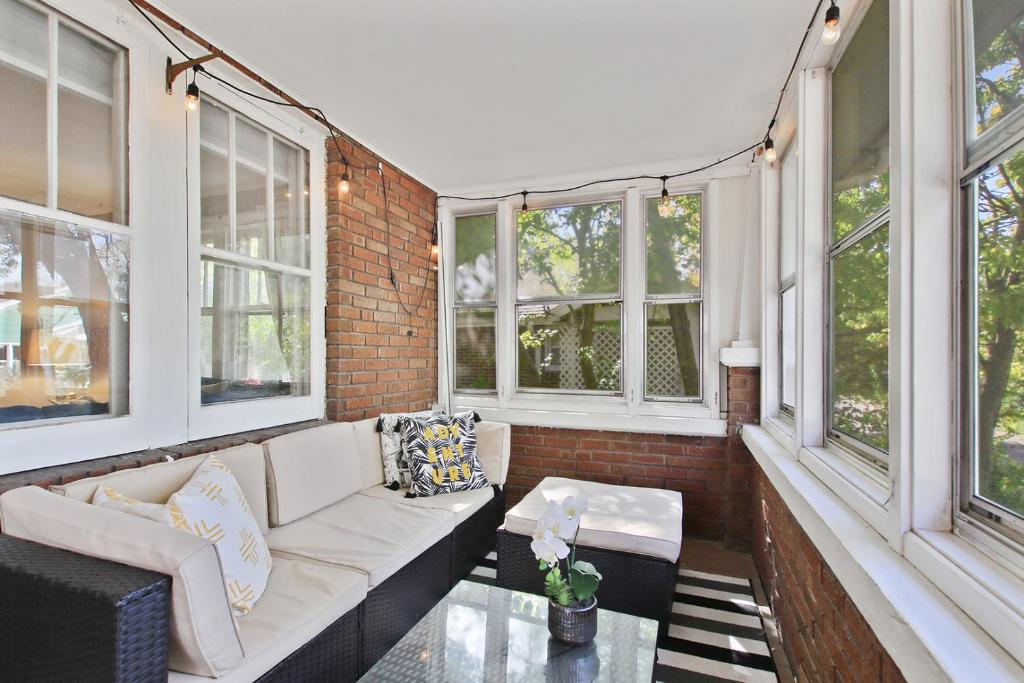 a screened in porch with a couch and windows at Bohemian Bungalow Pac-Man, walk downtown, pet friendly in Columbia