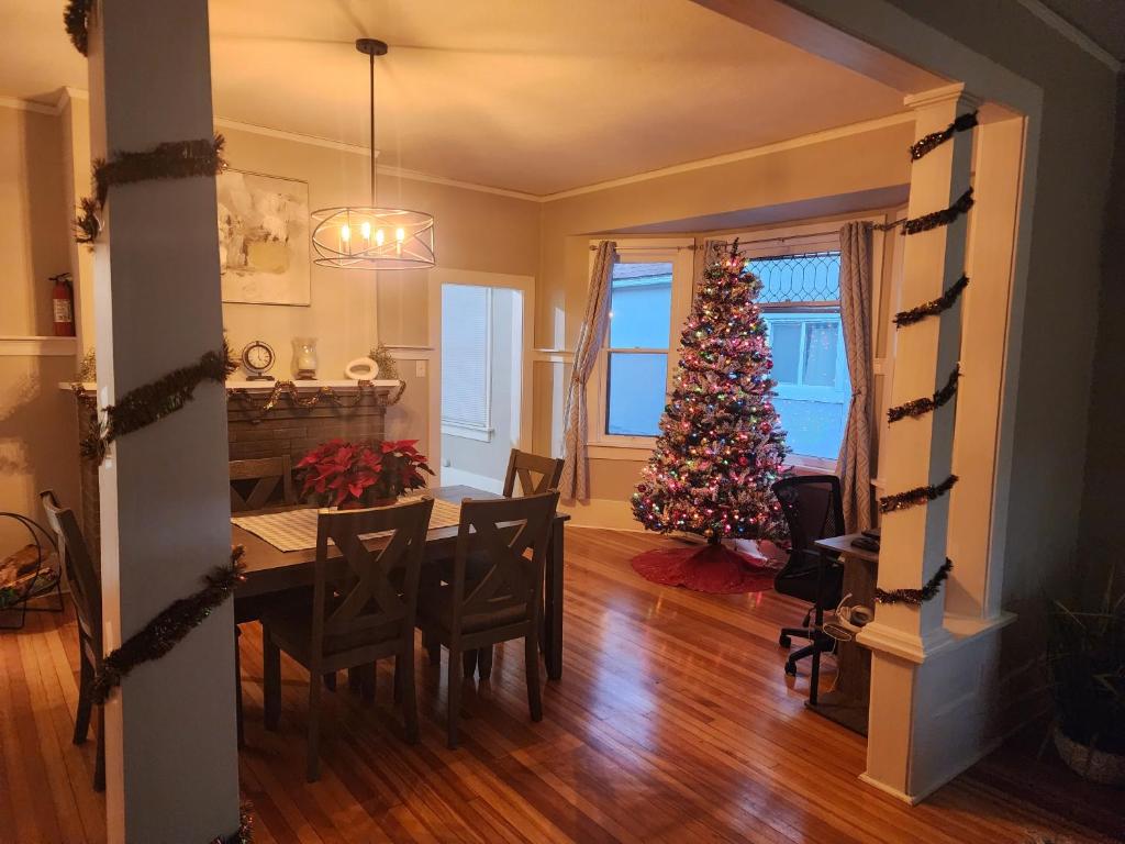 a dining room with a christmas tree and a table at Historic Home w/Pikes Peak Views in Colorado Springs