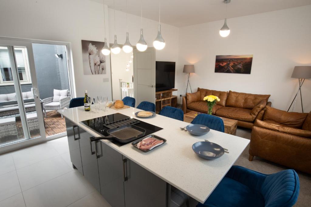 a kitchen and living room with a large island in the middle at Modern Buxton Town House in Buxton