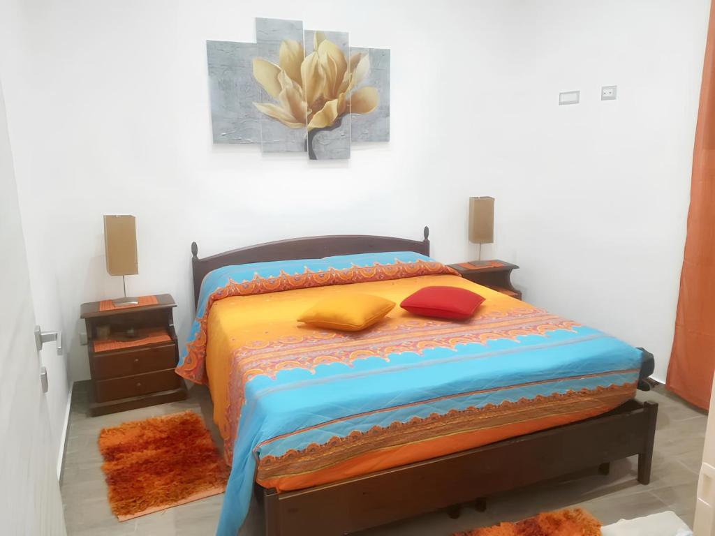 a bedroom with a bed and a plant on the wall at 2 bedrooms apartement with sea view furnished terrace and wifi at Pianoconte 2 km away from the beach in Piano Conte