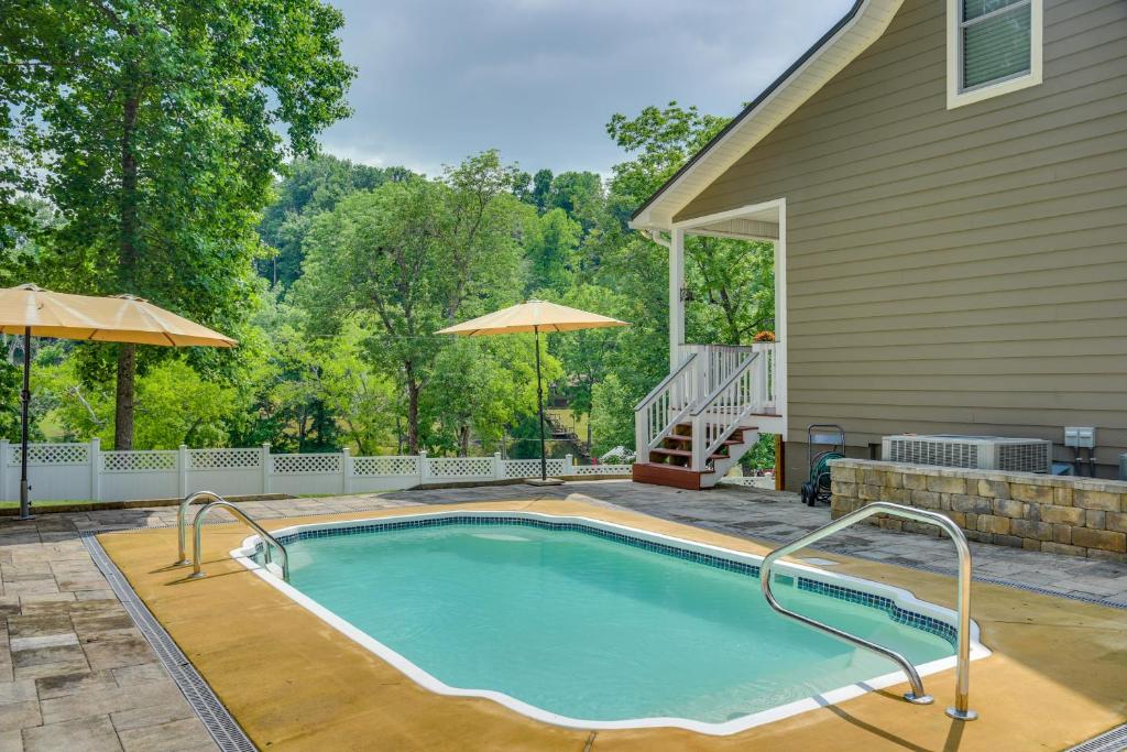a swimming pool in the backyard of a house at Modern Tims Ford Lake Home with Private Dock and Pool! in Lynchburg