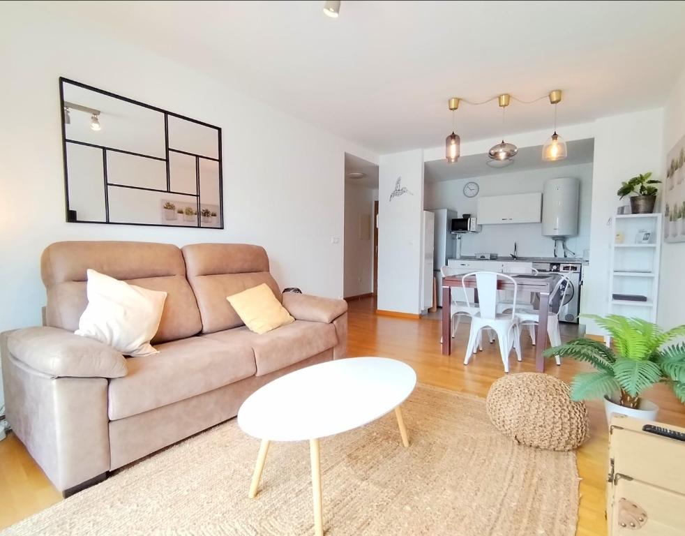 una sala de estar con un sofá y una mesa en Portbeach, en Viveiro