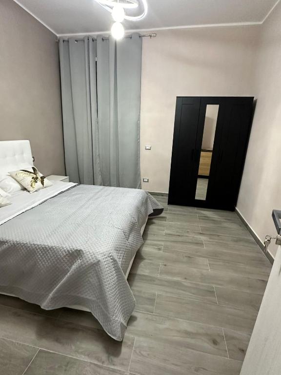 a bedroom with a large bed and a door at B&B Mageva Luxury Room in Naples