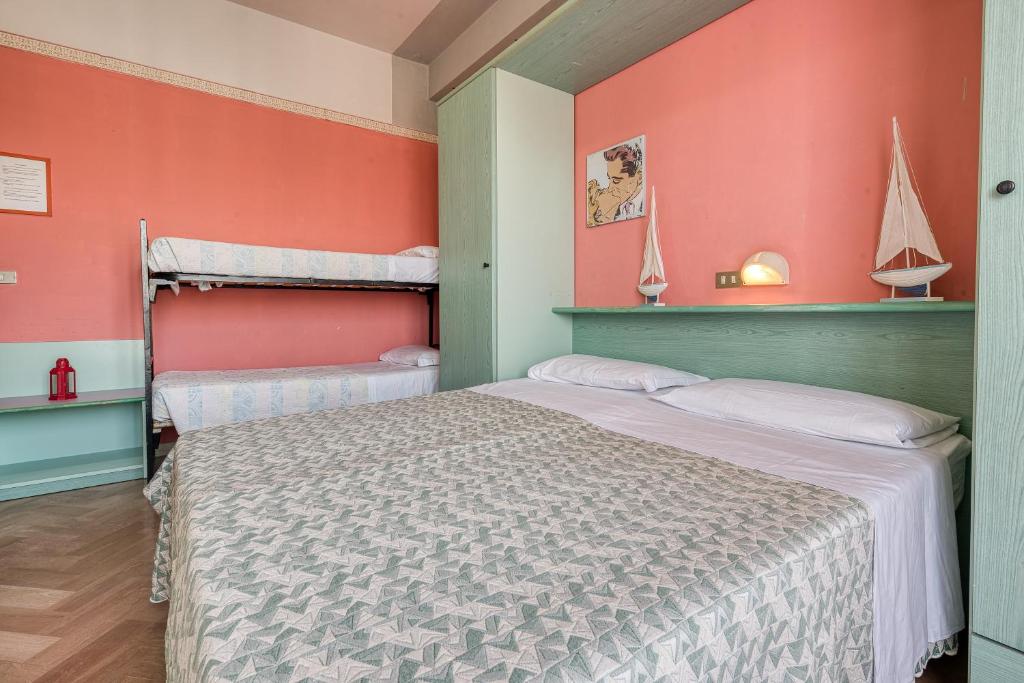 Postel nebo postele na pokoji v ubytování Hotel Sabbia d'Oro