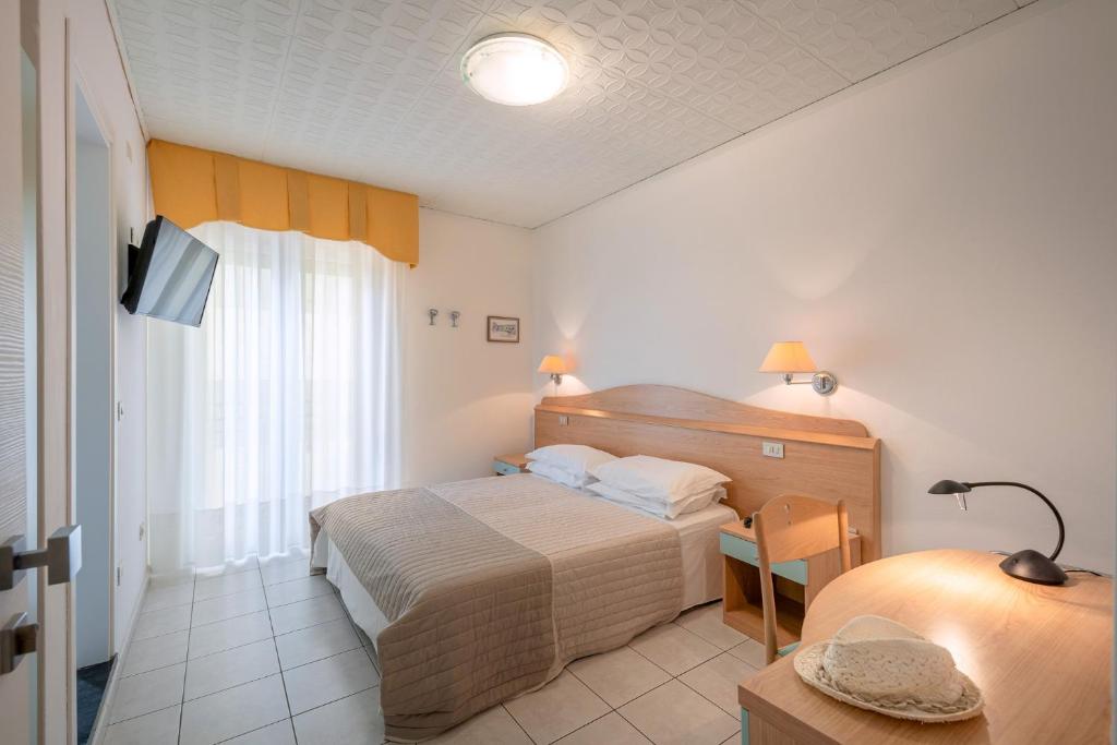Postel nebo postele na pokoji v ubytování Hotel Miramare