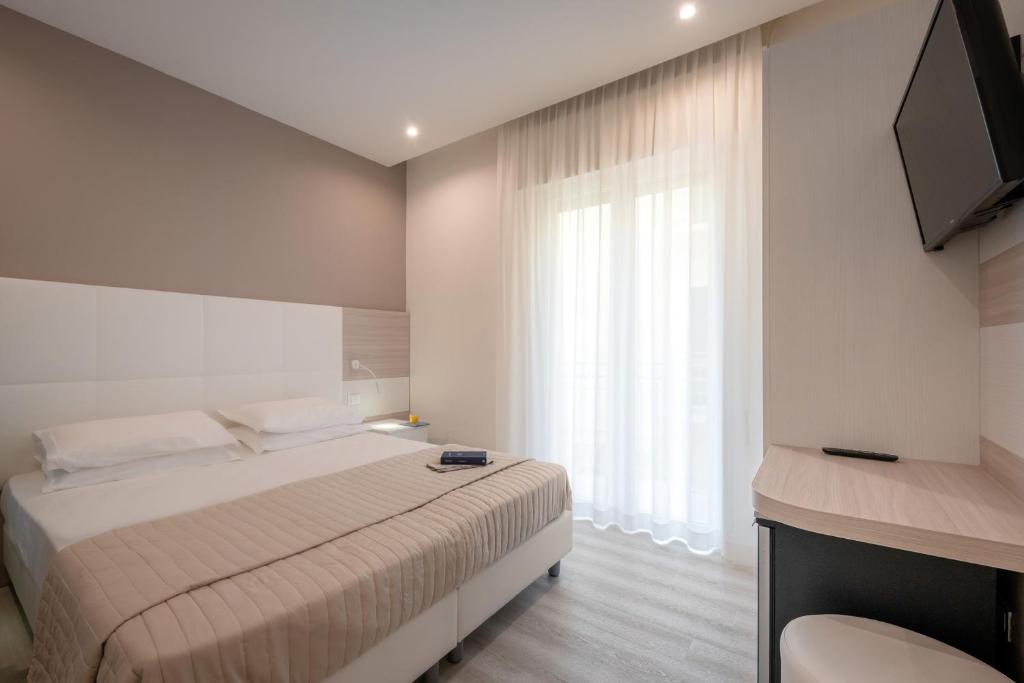 Postel nebo postele na pokoji v ubytování Hotel Miramare