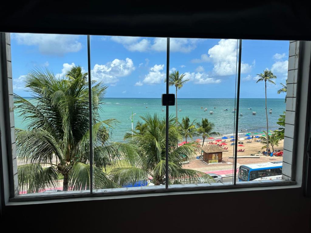 a view of the beach from a window at Apartamento Beira Mar em Maceió in Maceió