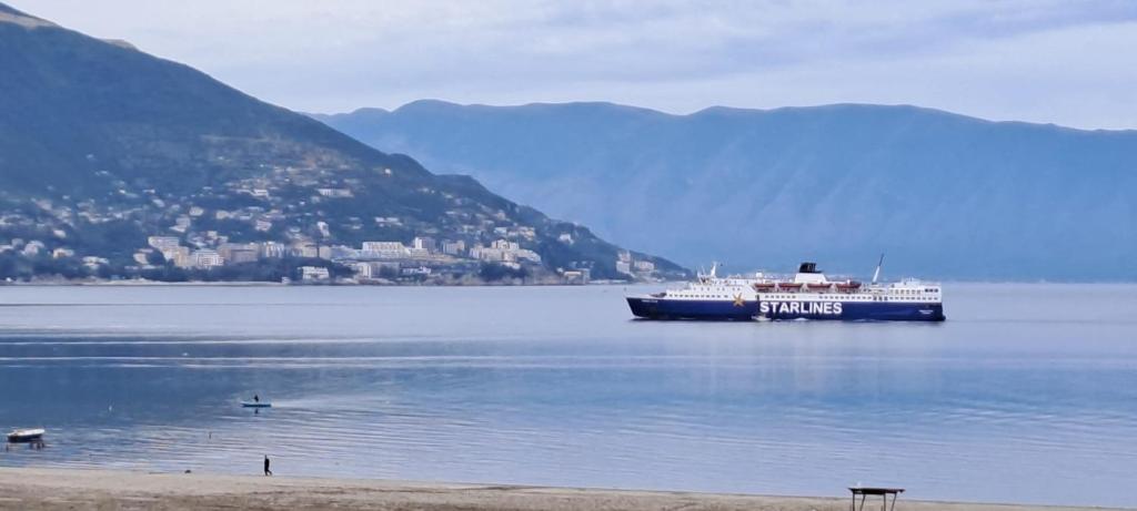 a large ship in the water near a beach at Seaside Apartment Plazhi vjeter in Vlorë
