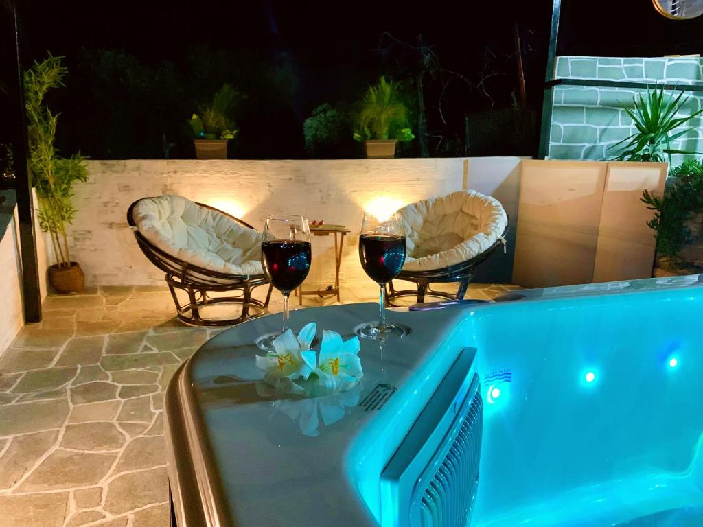 - un bain à remous avec deux verres de vin rouge dans l'établissement Thassion-ikea Jacuzzi private villa, à Astris