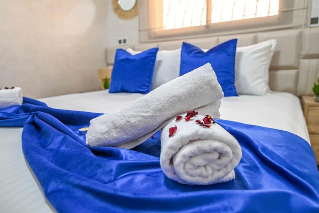 a towel sitting on top of a bed with blue sheets at The Skyline Stay in Marrakech