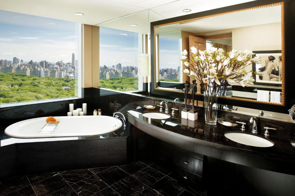 a bathroom with two sinks and a large window at Mandarin Oriental, New York in New York