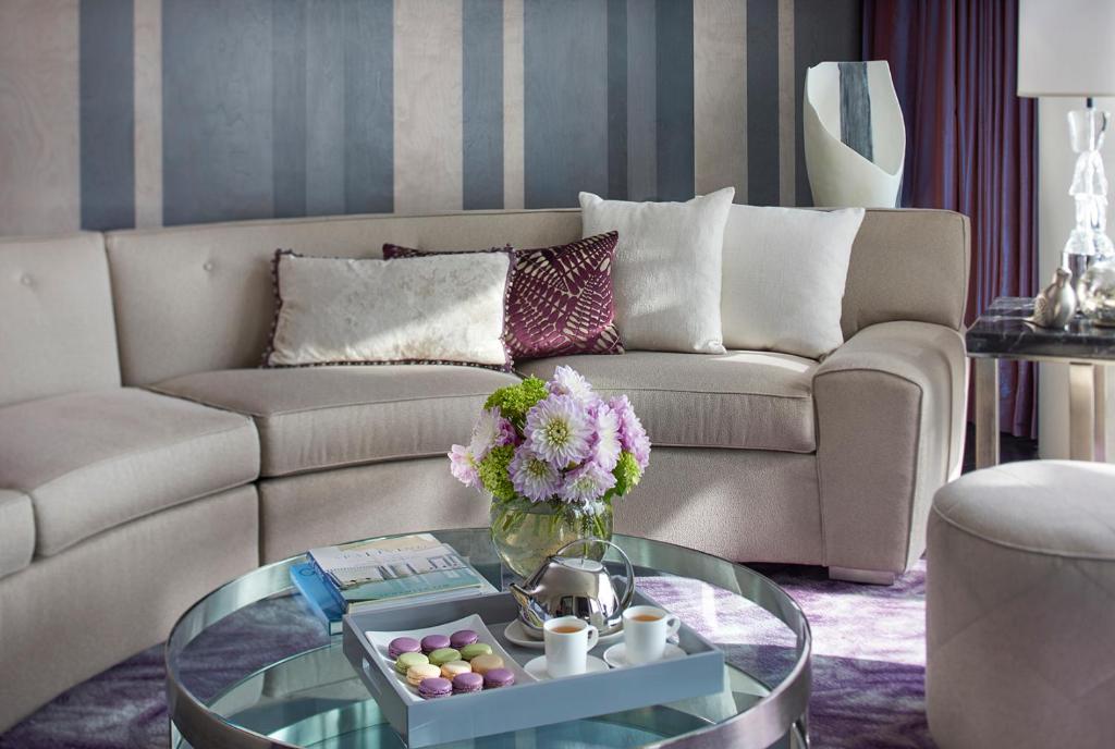 a living room with a couch and a glass table at Mandarin Oriental, New York in New York