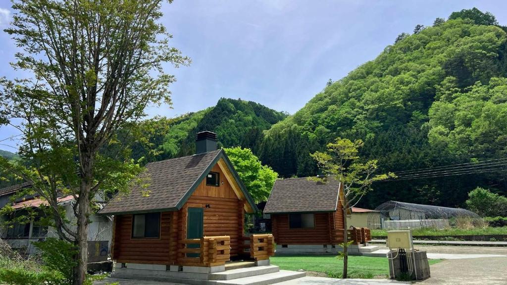 a log cabin with a mountain in the background at New Kurumi Land - Vacation STAY 41992v 