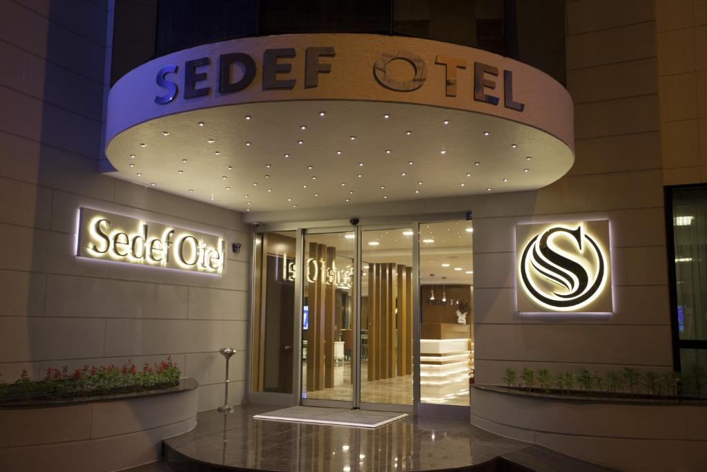 a building with a sign for a seceded oil store at Giresun Sedef Hotel in Giresun