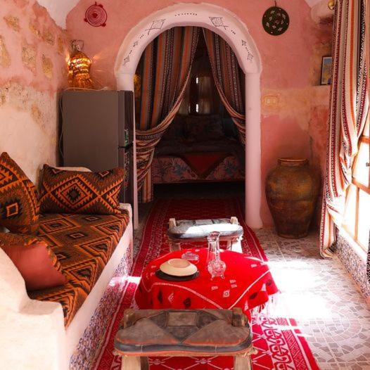 a living room with a couch and a table at Gite Douiret in Ad Duwayrāt
