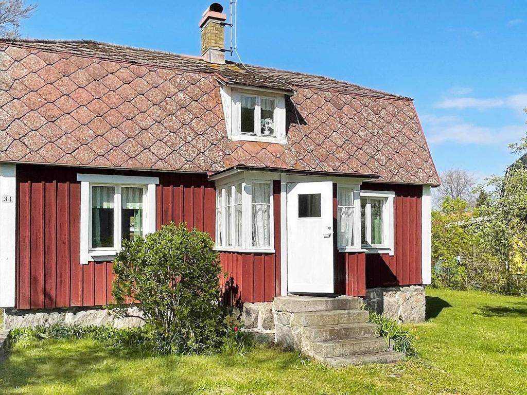 una vieja casa roja y blanca con chimenea en Holiday home SÖLVESBORG XI, en Sölvesborg