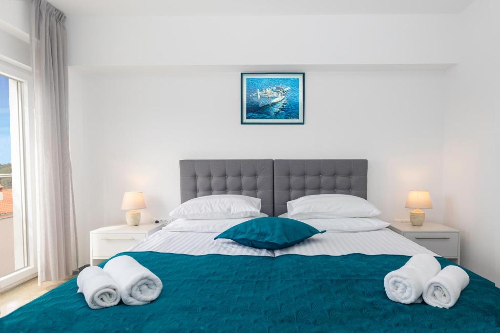 a bedroom with a large bed with towels on it at Villa Grace in Rovinj