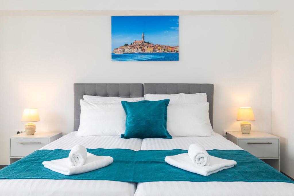 a bedroom with a bed with two towels on it at Villa Grace in Rovinj