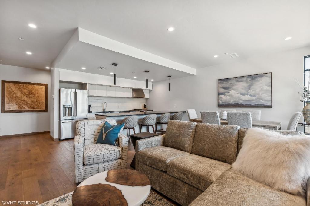 a living room with a couch and a kitchen at Discover Luxury at Cantera 303 in Whitefish