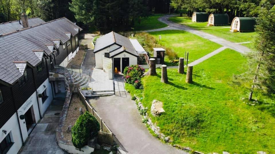 an aerial view of a house with a yard at Rooms & Camping Pods at Colliford Tavern in Bodmin