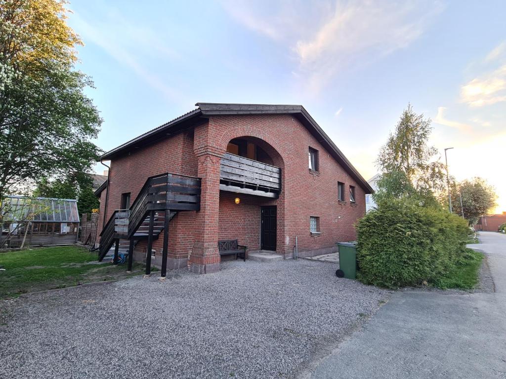 a brick building with a spiral staircase in front of it at DT Serene Villa - Lillestrøm in Lillestrøm