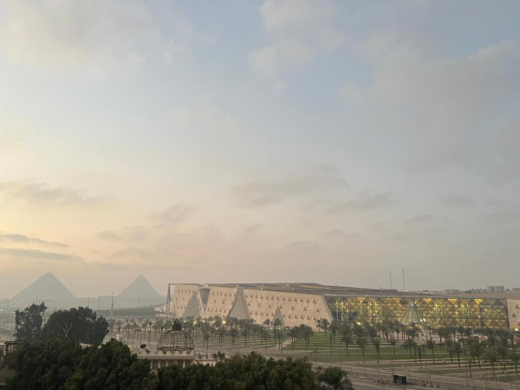 a view of the pyramids and buildings in the city at Palm Grand Egyptian Museum in Cairo