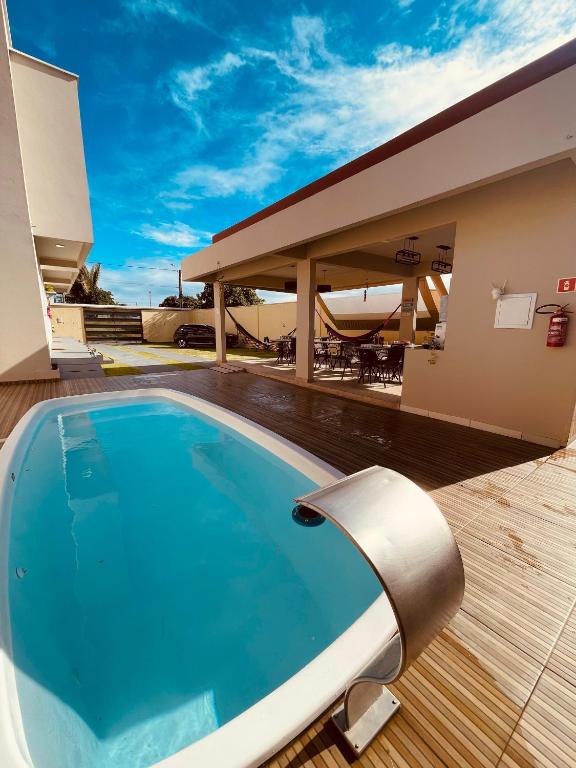 a swimming pool on the deck of a house at Residencial Floreana Apto Estrela in Salinópolis