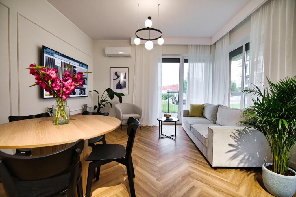 a living room with a table and a couch at Apartament Indigo 11 by Housine in Zator