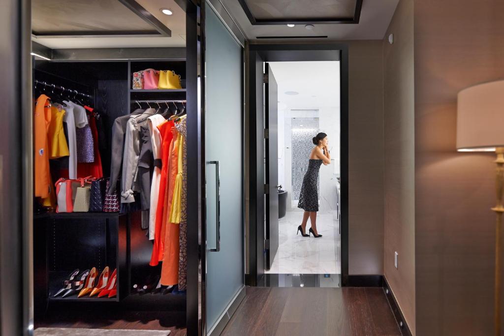 a woman standing in front of a closet at Mandarin Oriental, New York in New York
